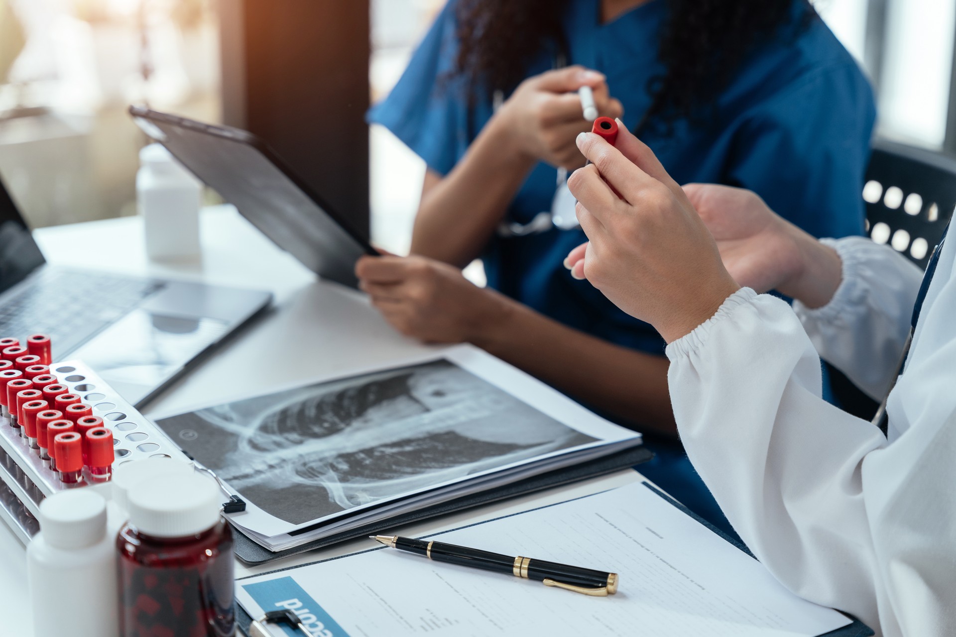 Doctor team, analysis the blood test examination results and medication usage of the patient on the chart, medical check-up concept.